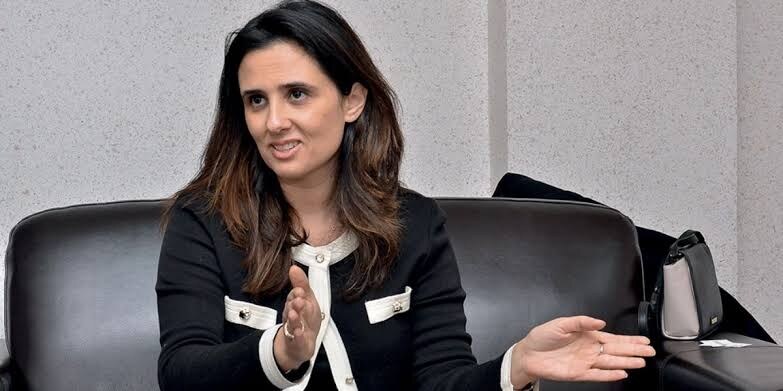 Lamia Tazi in discussion during a seated panel, gesturing while speaking
