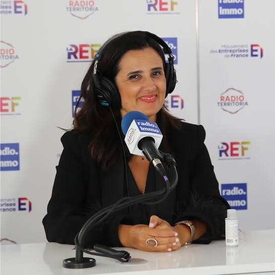 Lamia Tazi during a radio interview wearing headphones