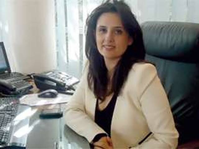 Lamia Tazi at her desk in an office setting